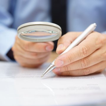 Magnifying glass against a contract